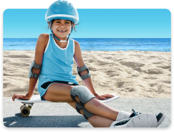Child skateboarding at the beach.